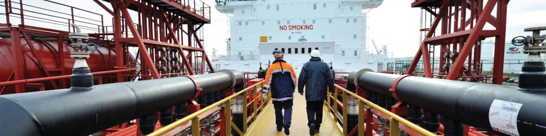 Employee walking along on a tanker