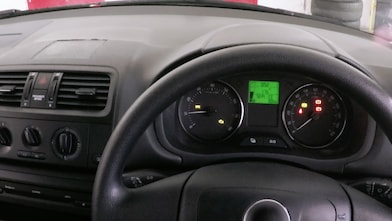 Car dashboard with multiple illuminated warning lights and steering wheel
