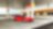 A red Ferrari sitting on a Shell station forecourt with a man leaning on a petrol pump