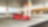 A red Ferrari sitting on a Shell station forecourt with a man leaning on a petrol pump