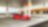 A red Ferrari sitting on a Shell station forecourt with a man leaning on a petrol pump