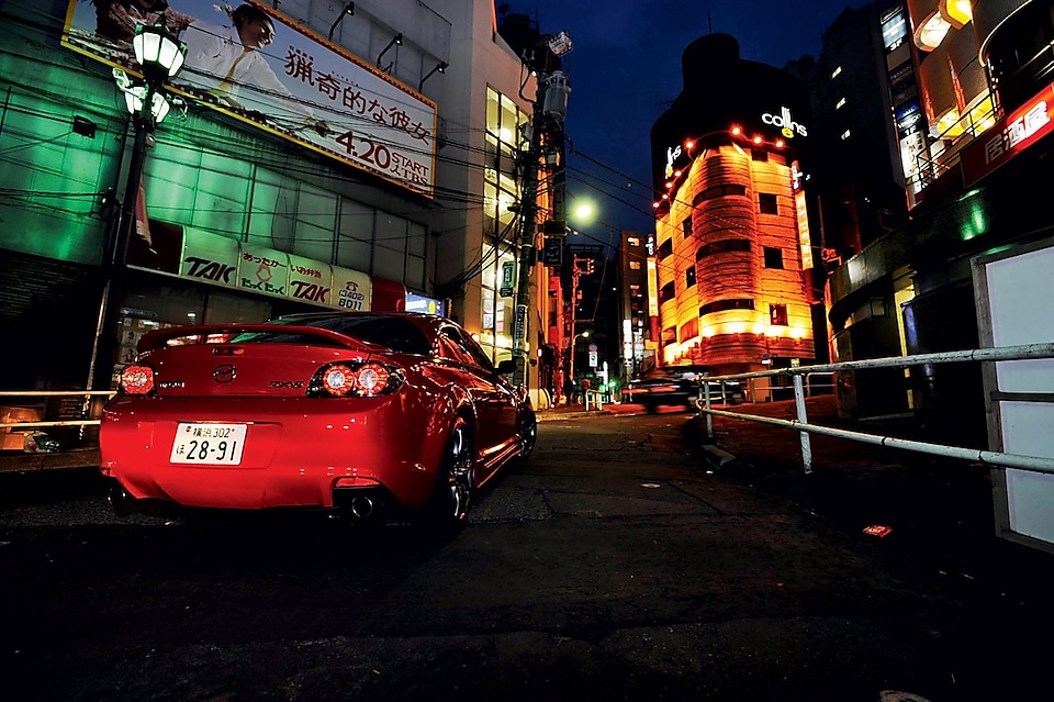 Mazda driving at night in Tokyo