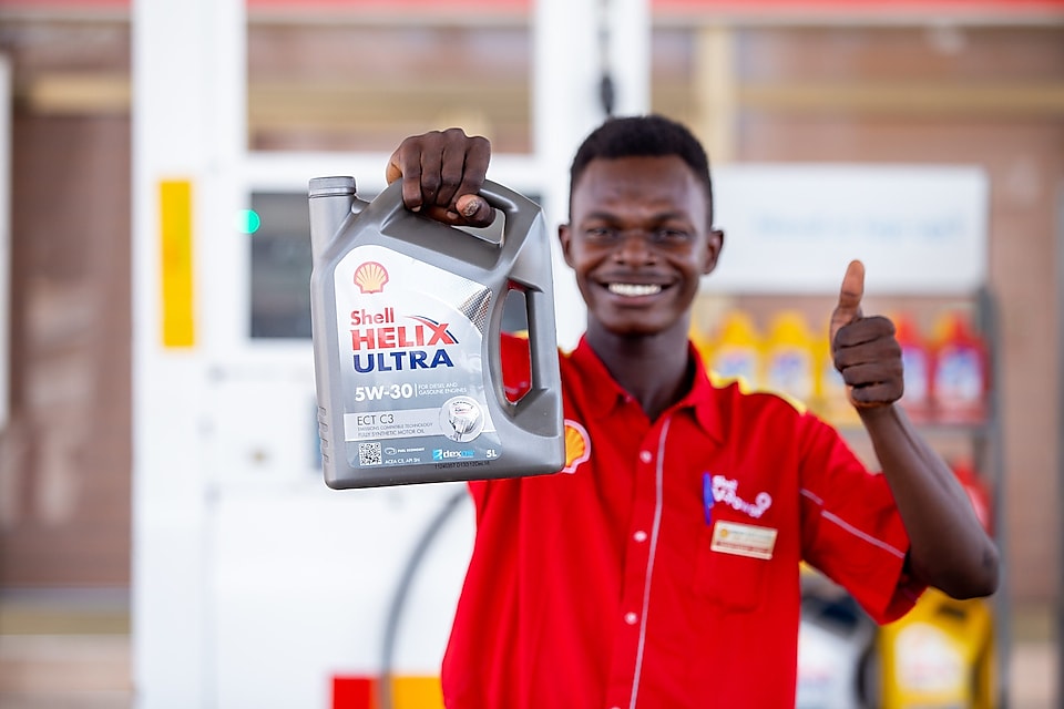 Ghanaian Customer Champion holding Shell Helix Ultra carton