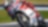 ducati superbike with rider cornering at speed on a racetrack