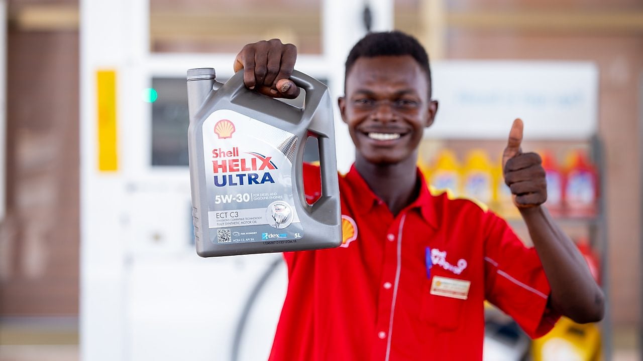 Ghanaian Customer Champion holding Shell Helix carton