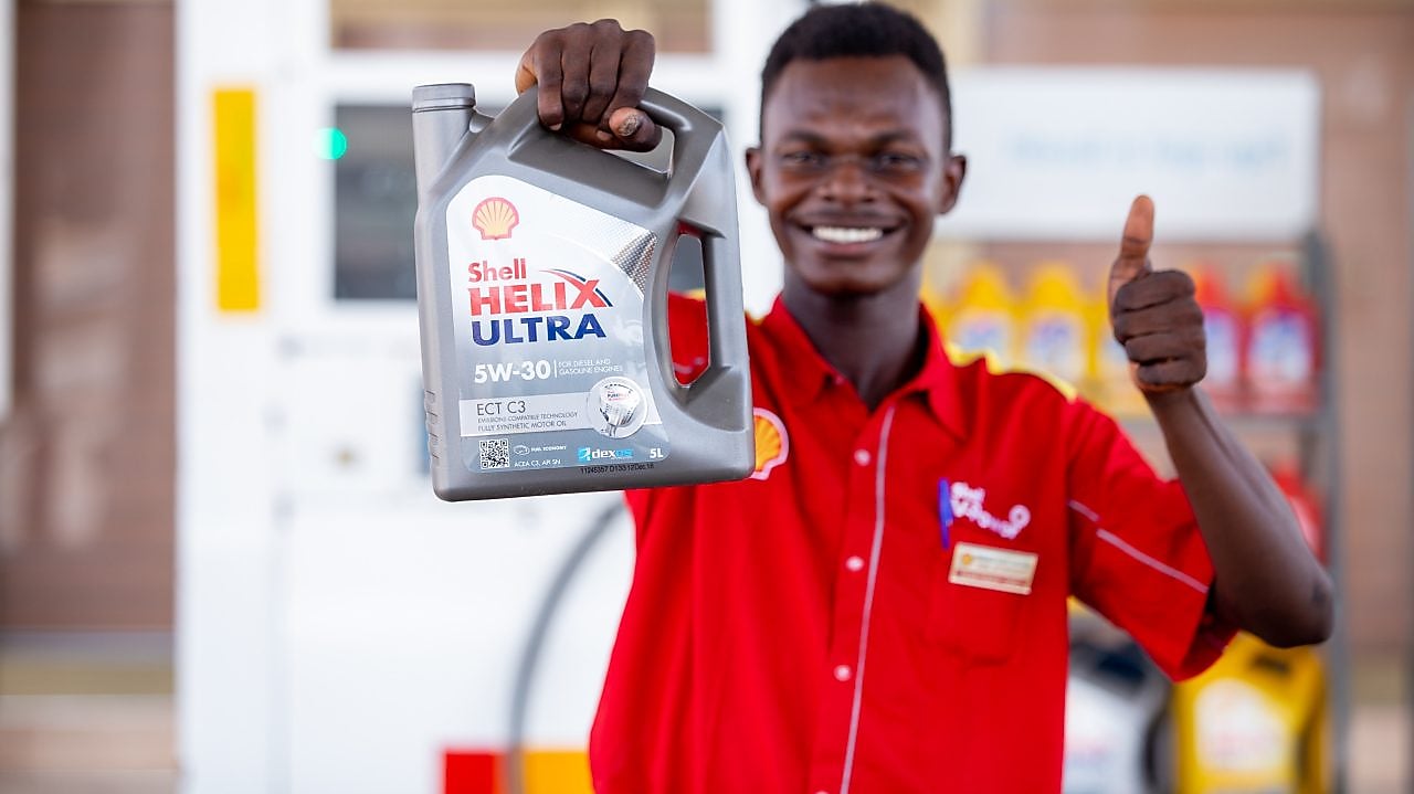 Ghanaian Customer Champion holding Shell Helix carton