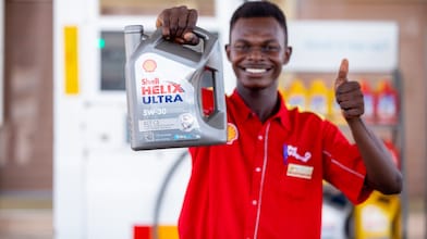 Shell Customer Champion holding Shell Helix Ultra 5W-30 motor oil thumbs up