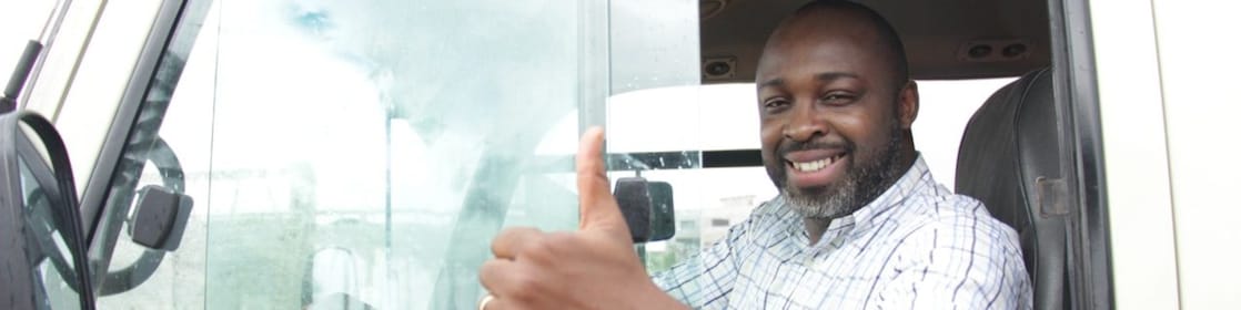 truck driver showing thumbs up from vehicle