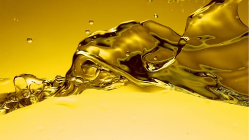 Golden Shell engine oil flowing in dynamic wave pattern