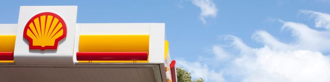 Shell fuel station signage under clear blue sky